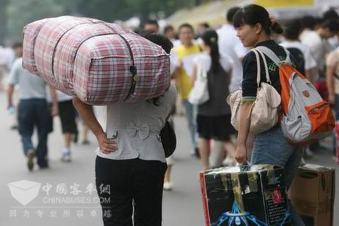 长沙汽车东站外一位肩扛行李的母亲